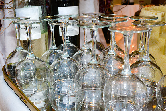 Long stemmed wine glasses with bottles of red and white wine