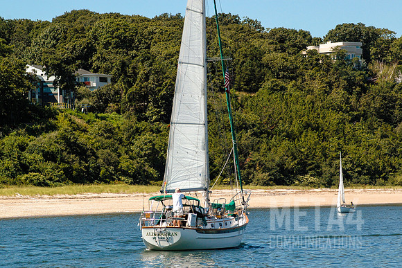 Sailboat Motoring on Harbor Channel