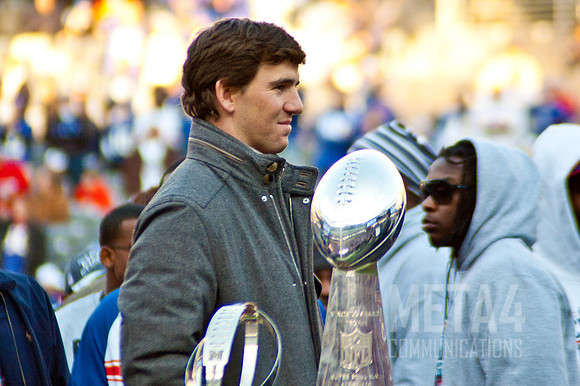 Eli Manning Poses with the Super Bowl XLVI Trophy | Super Bowl XLVI Celebration at MetLife Stadium