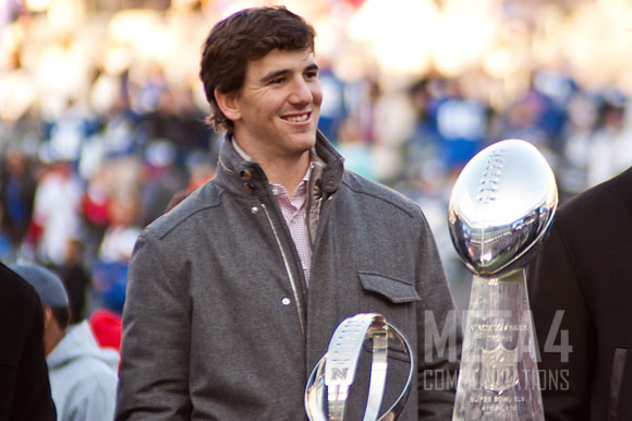 Eli Manning Poses with the Super Bowl XLVI Trophy | Super Bowl XLVI Celebration at MetLife Stadium